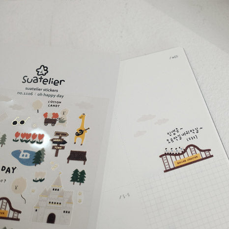 Set of small stickers with cartoon designs on a white card, featuring the brand 'Suatelier'.