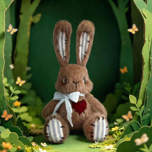 Stuffed rabbit toy with a white bow tie and red heart in a forest setting