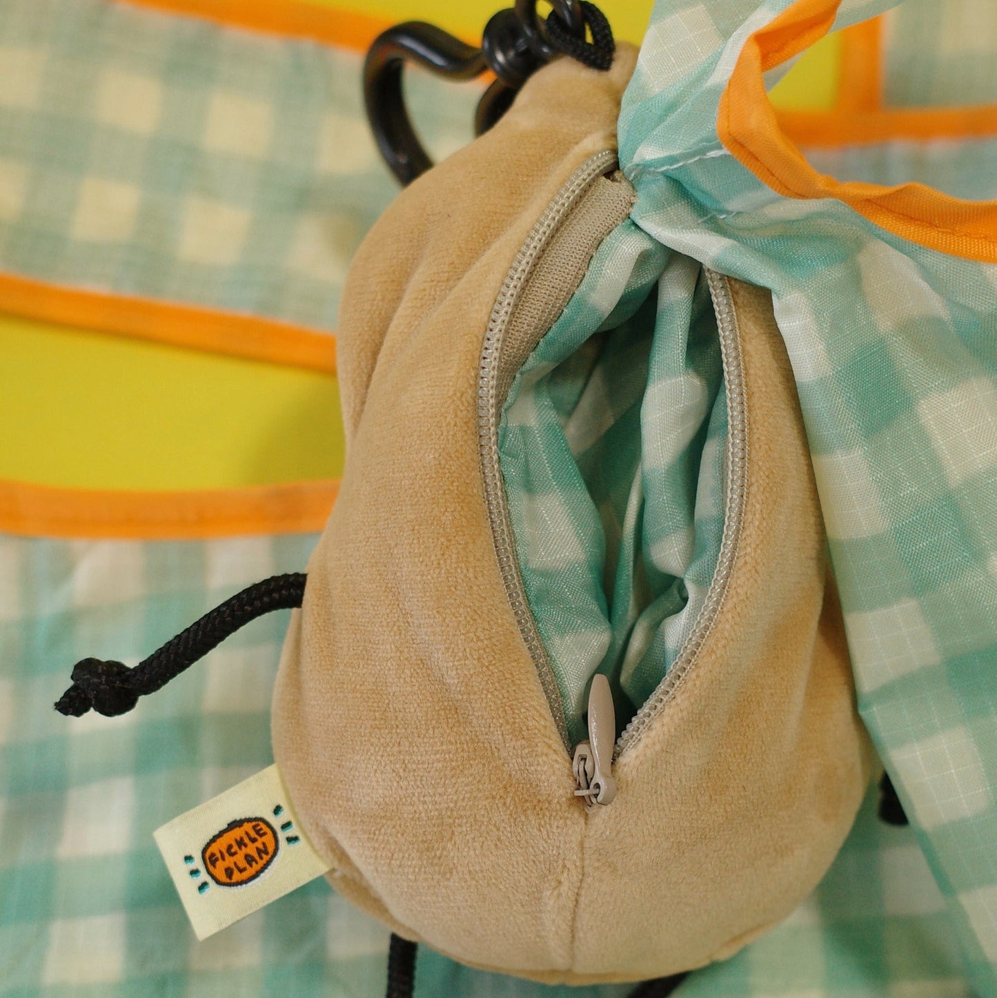 Beige drawstring pouch with a colorful patterned fabric background