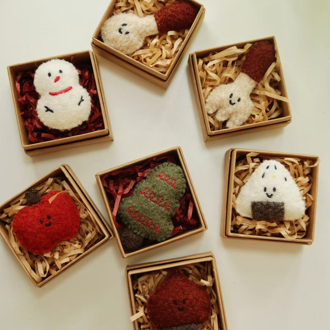 Small decorative items in miniature boxes on a white surface
