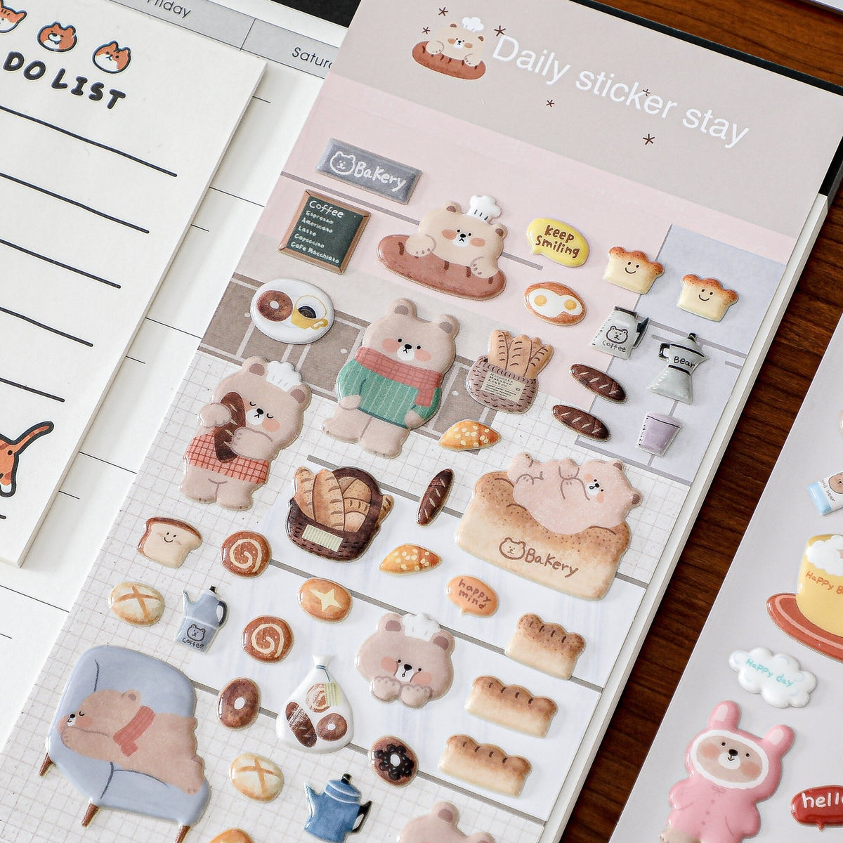 Sheet of cute animal-themed stickers with cartoon bears and other characters on a wooden surface.
