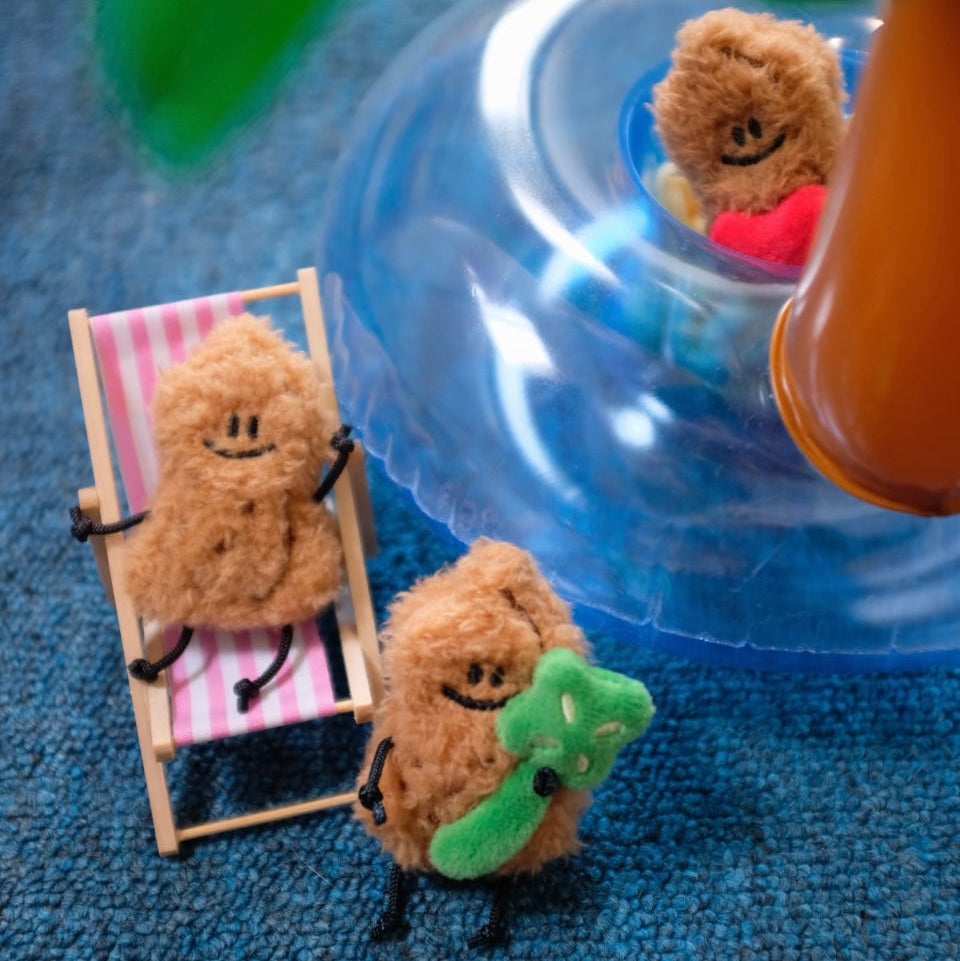 Small plush toys on a blue surface with a blurred background