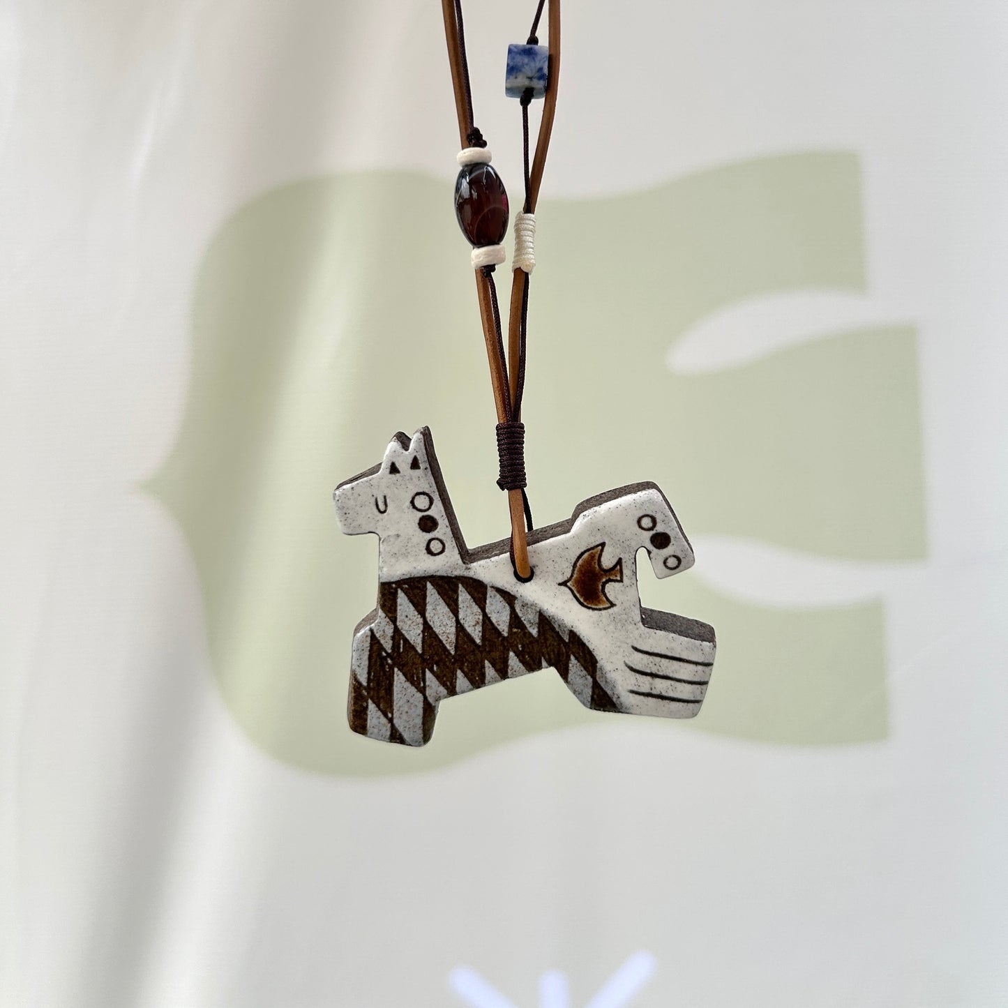 Necklace with a 8 leg horse pendant on a white background