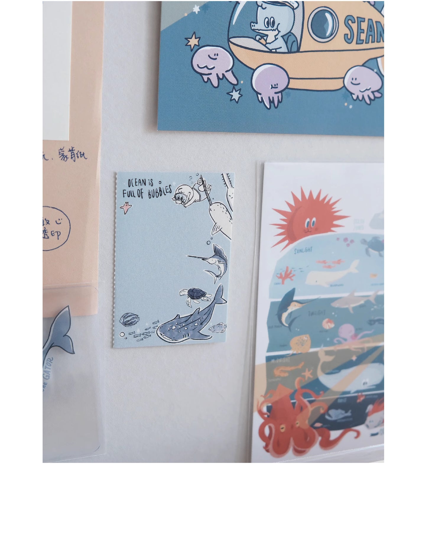 Collection of illustrated cards featuring ocean-themed designs on a white surface.