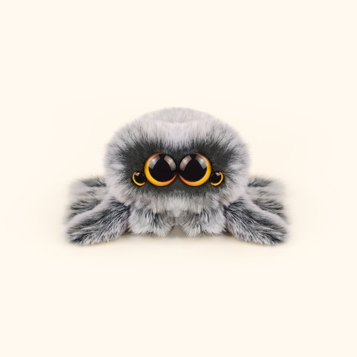 Plush toy spider with large eyes on a white background