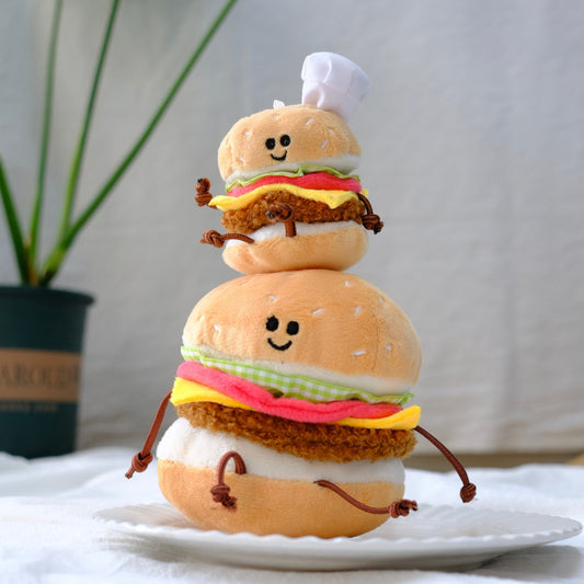 Stack of plush toy hamburgers on a white plate with a neutral background