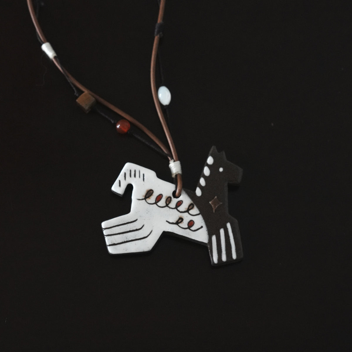 Her Market | Black Infinity Pattern Whimsical 8-Leg Pony Necklace