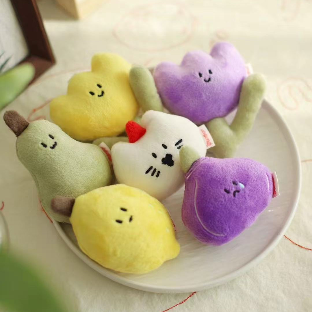 Colorful plush toys shaped like cartoon characters on a white plate.