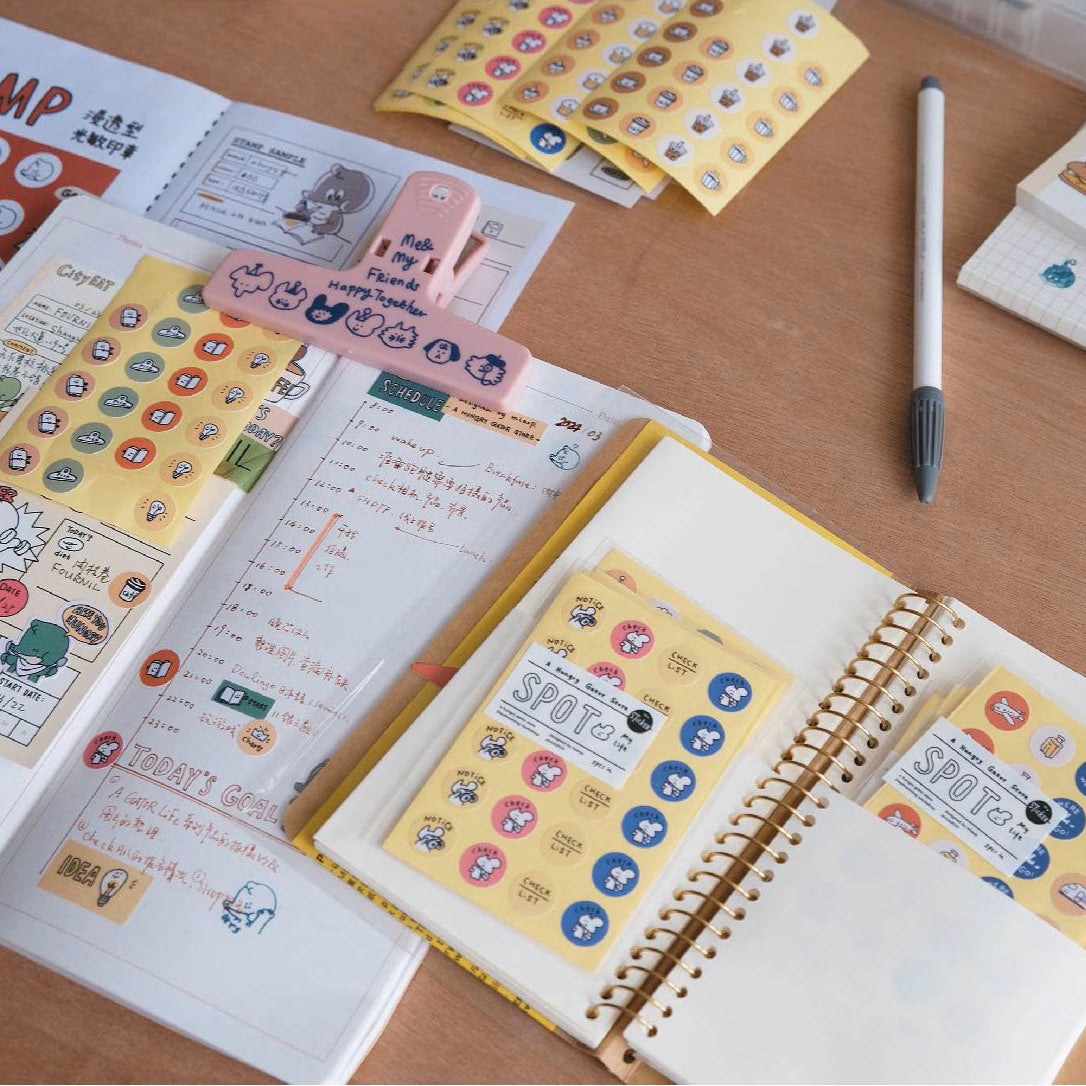 Open notebooks with stickers on a wooden surface