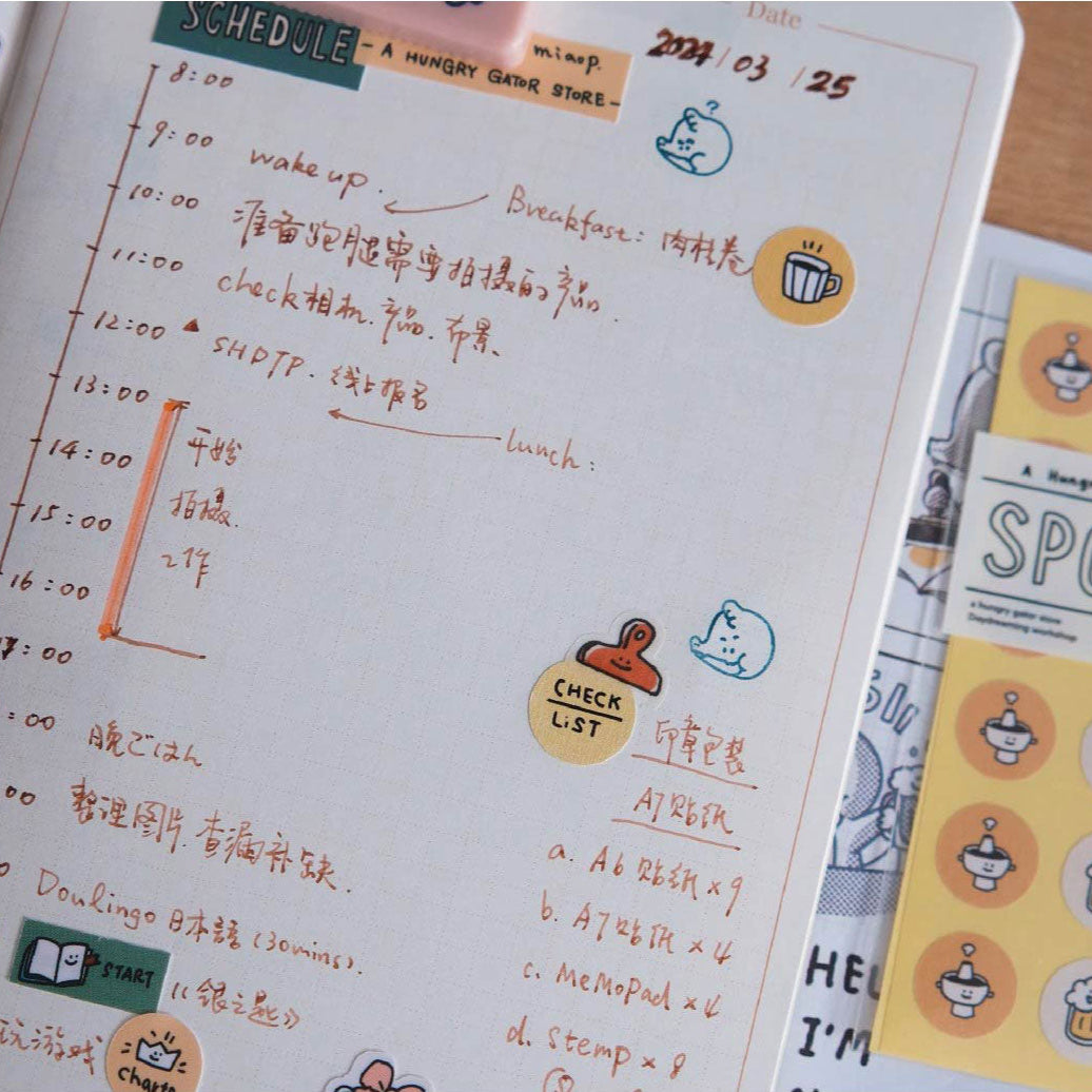 Notebook with a schedule and colorful stickers on a wooden surface