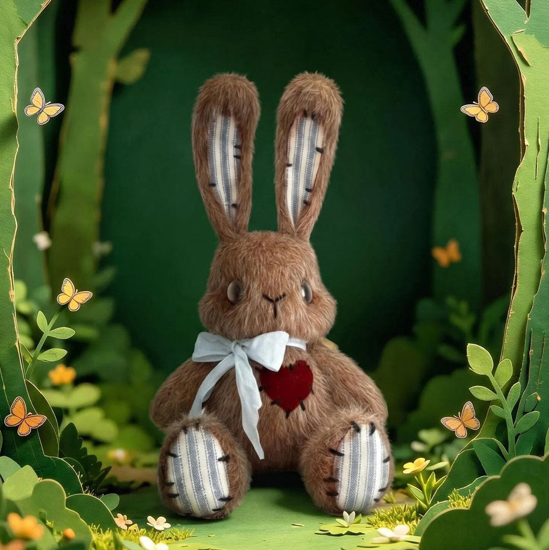 Stuffed rabbit toy with a white bow tie and red heart in a forest setting