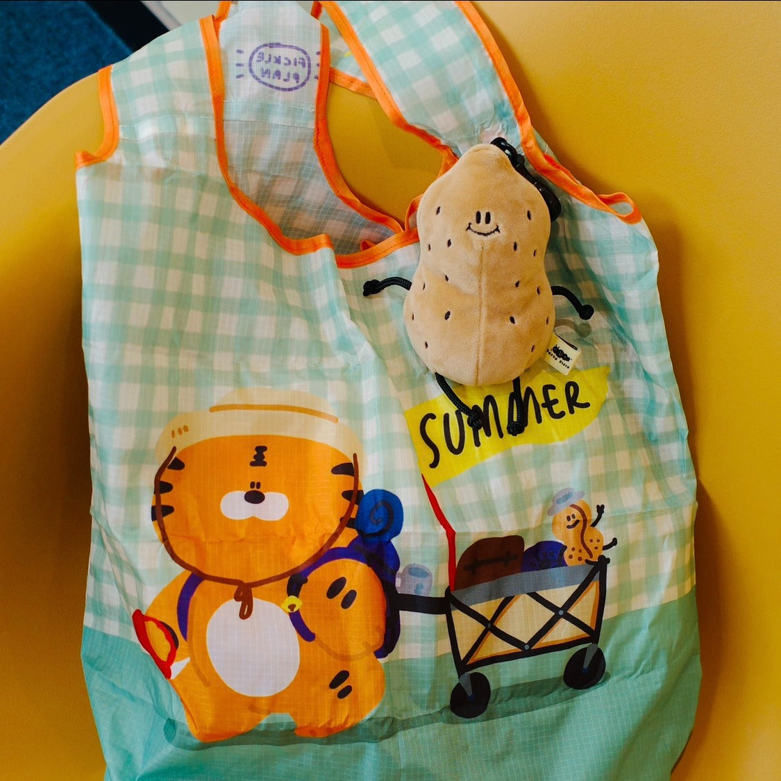 Children's apron with cartoon tiger design and 'summer' text on a yellow background