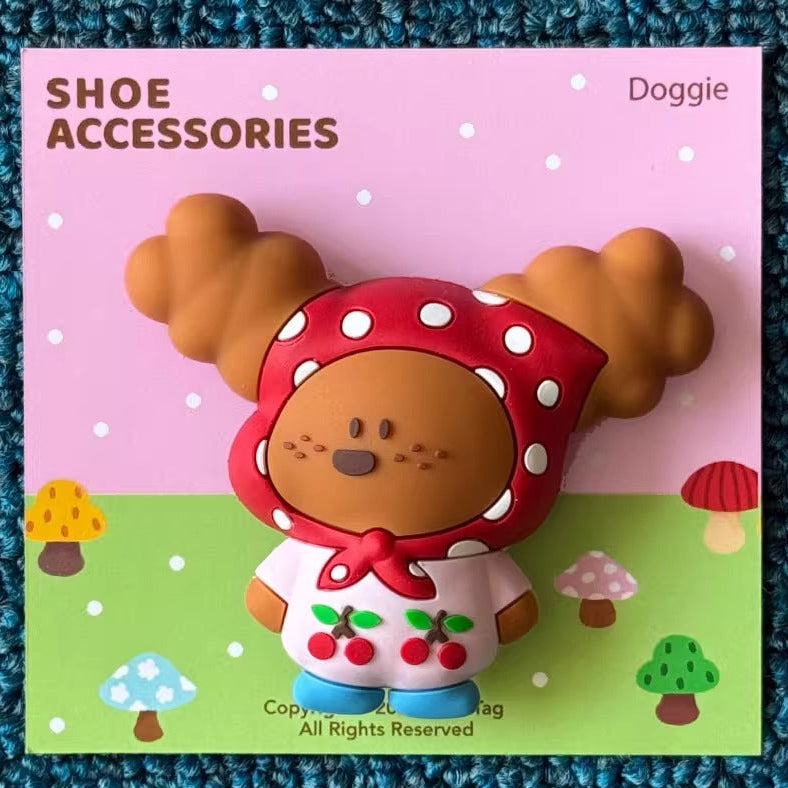 Shoe accessory with dog design on a pink card labeled 'SHOE ACCESSORIES' on a textured blue surface.