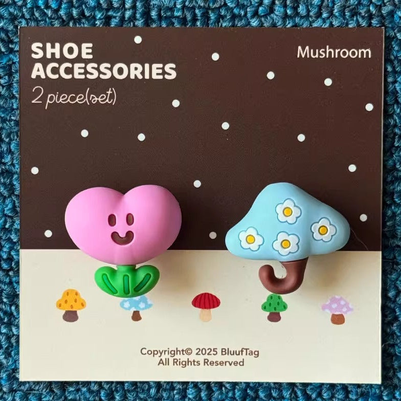 Mushroom-shaped shoe accessories on a product card with Bluedog branding, displayed on a textured blue surface.