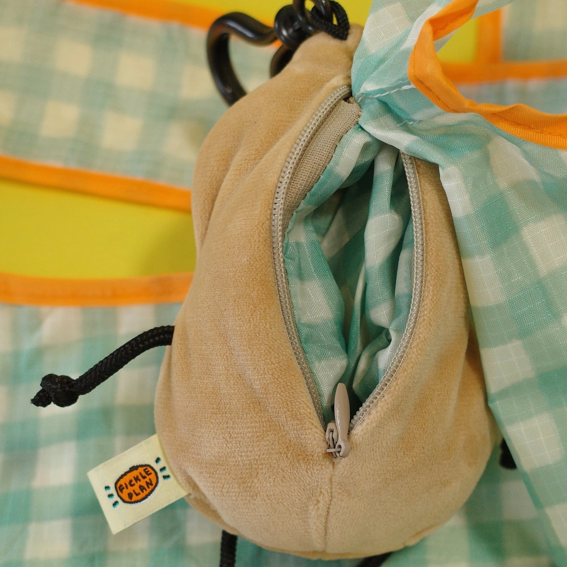 Beige drawstring pouch with a colorful patterned fabric background