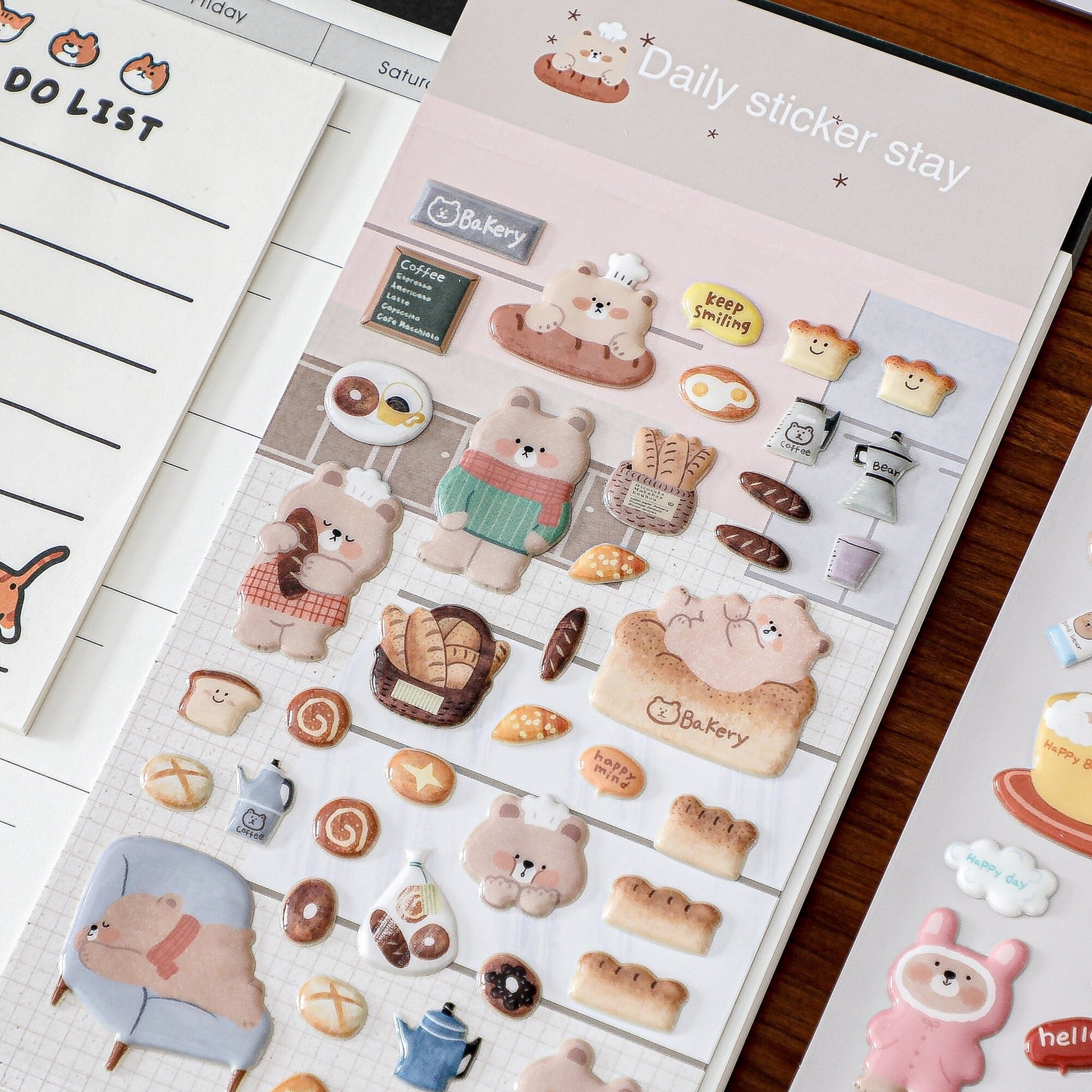 Sheet of cute animal-themed stickers with cartoon bears and other characters on a wooden surface.