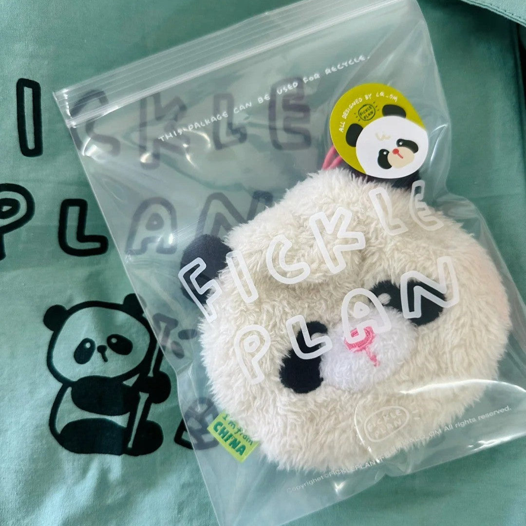 Plush keychain in clear packaging on a green background with panda design