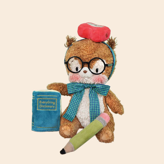 Stuffed animal with glasses, a book, and a smartphone on a beige background