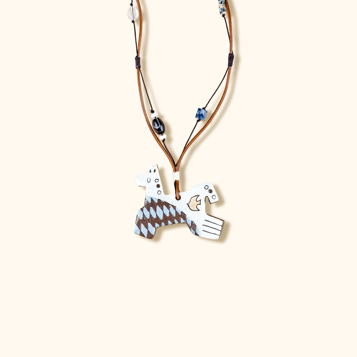 Necklace with a unique pendant on a beige background