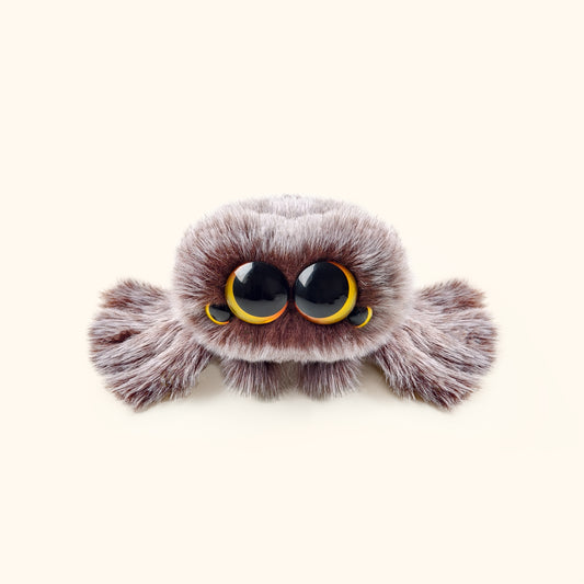 Plush toy resembling a spider with large eyes on a white background