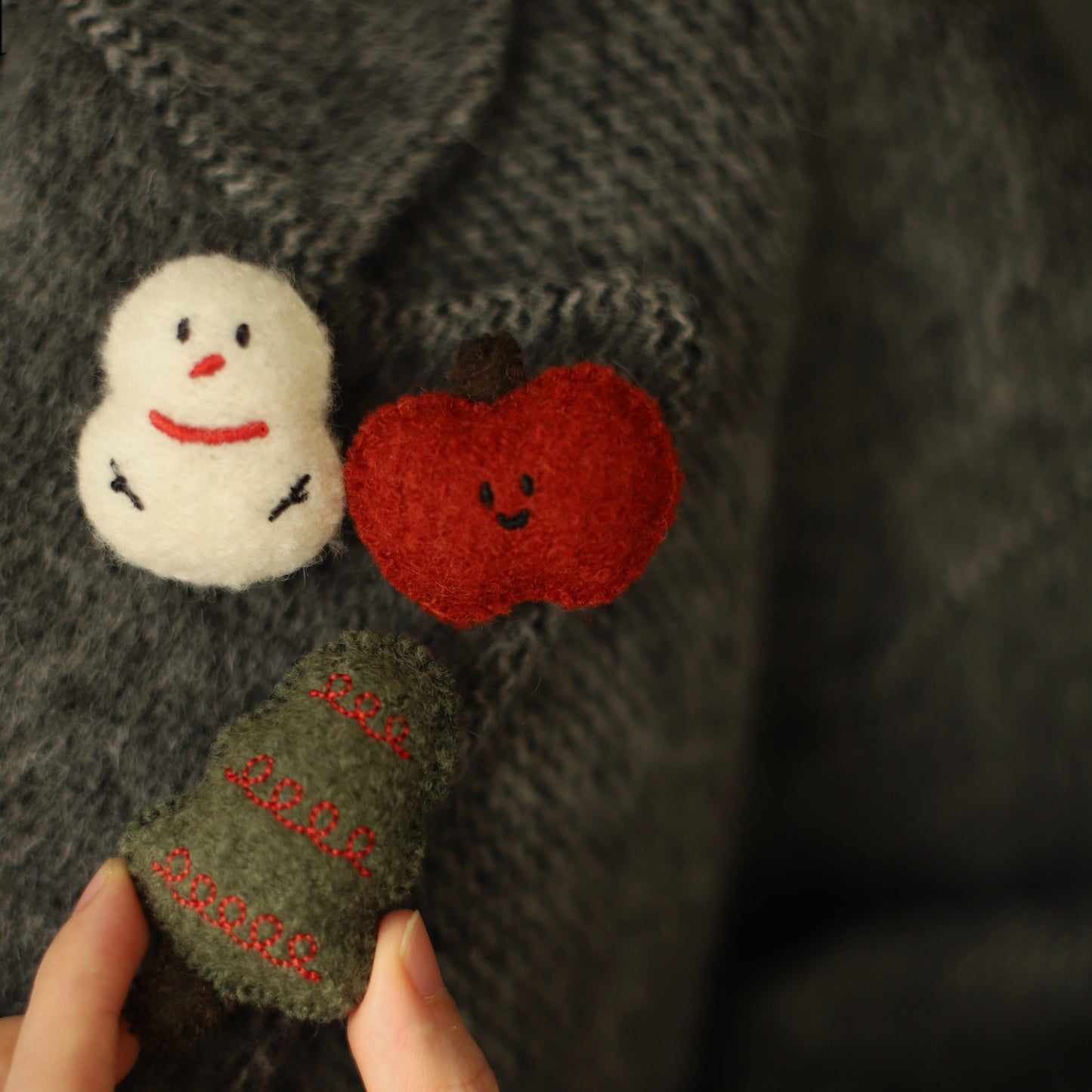 Handmade felt decorations on a dark fabric background